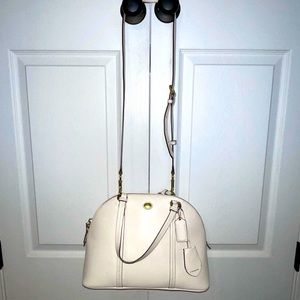 White coach bag with gold details.